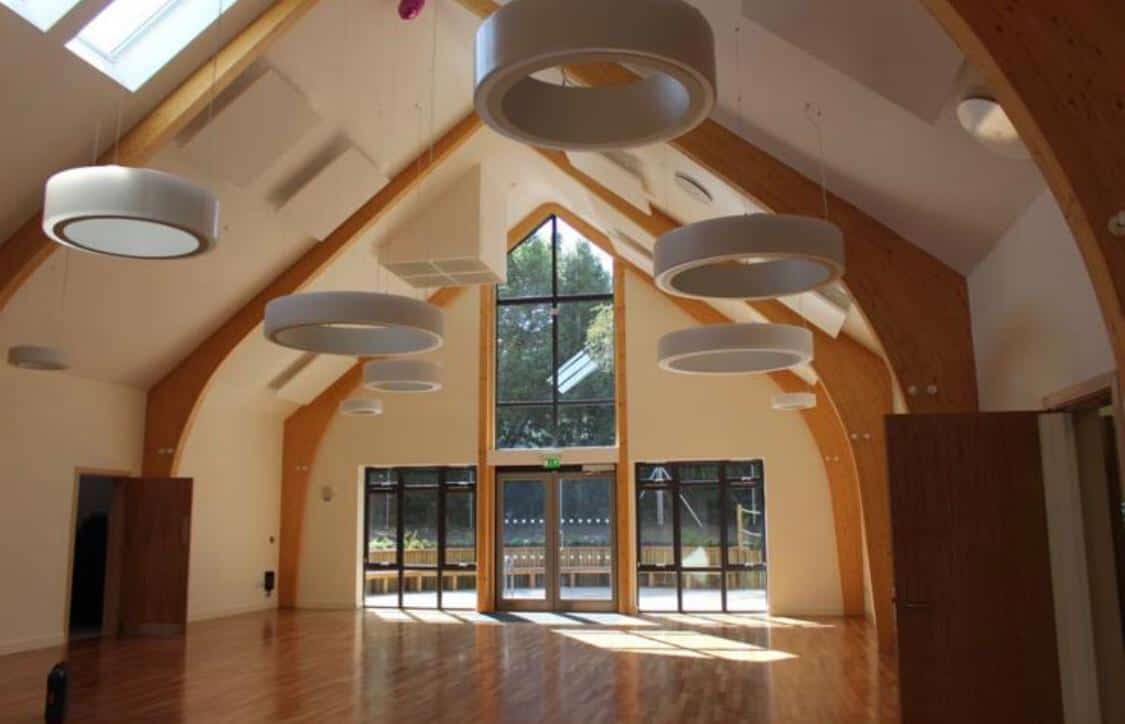 Circular lights hanging from the Herne Community Centres main hall